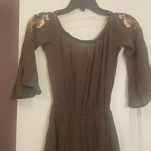 Olive green romper with flower accents.